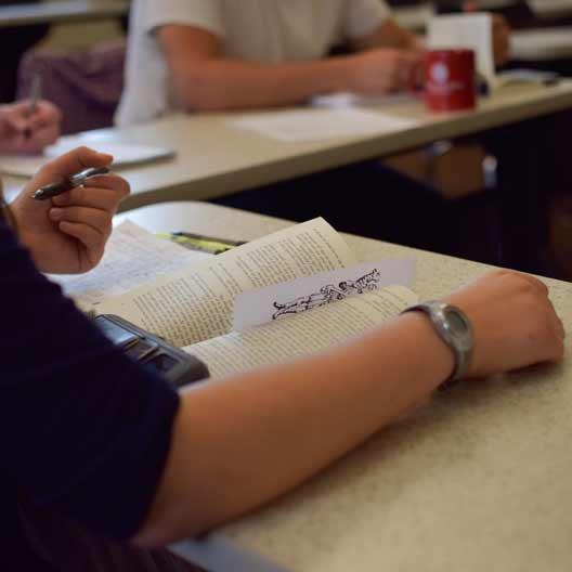 A student reading a book in class